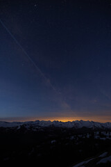 The summer Milky Way rises over the mountains in the alps in Switzerland. Centre of the Galaxy. Astrology concept.