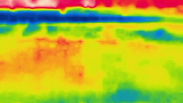 A irregular flicker of red and blue spots. Abstract dynamic picture, how to scroll a damaged film.Image from thermal imager device.