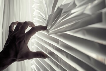 A person reaching out of a window with blinds in the background. Suitable for various design projects