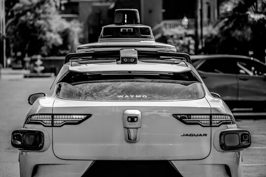 Phoenix, Arizona, USA - 3.23.2024: Behind a Waymo self-driving car stopped at an intersection.