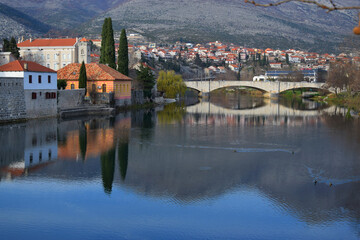 Bosnia and Herzegovina, Trebinje city, old town stone bridge and river on a sunny autumn day with clear blue sky. Mountains in the background.
