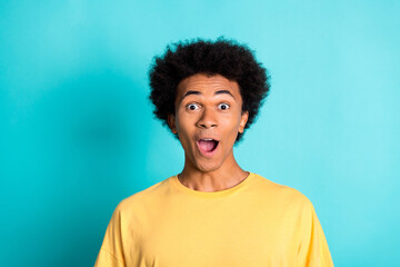 Photo of impressed guy with afro hairdo dressed yellow t-shirt astonished staring open mouth...