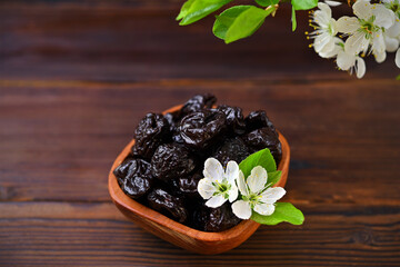dried prunes in a bowl on the table close-up