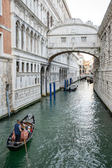 Fototapeta na wymiar Venice, Italy: iconic spot with the Bridge of Sighs and a gondola on the canal Rio di Palazzo 