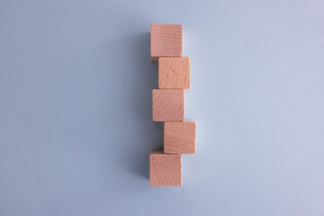 Hand arranging wood cube stacking as step stair. Business concept growth success process on blue background, copy space.
