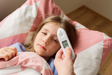 sick girl with measuring temperature. high quality photo