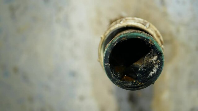 Sewer wash-basin cleaning sink sewage kitchen blockage pipe drain cleaning and septic cesspool pumping siphon into wash leak. The sump flowing contains pollution sludge water black wastewater