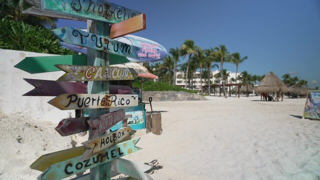 View of destination signpost, beach and hotels near Puerto Morelos, Caribbean Coast, Yucatan Peninsula, Mexico, North America