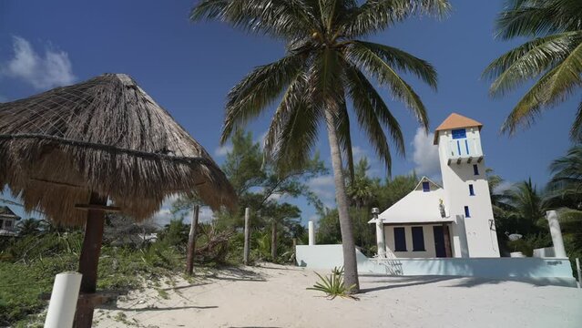 View of palm trees and white beach house with tower near Puerto Morelos, Caribbean Coast, Yucatan Peninsula, Mexico, North America