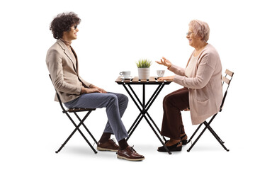 Young man and elderly woman having coffee and talking