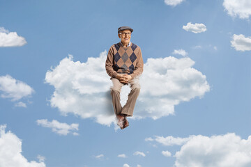 Elderly man floating on a cloud