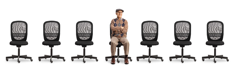 Elderly man sitting in an office chair with other empty chairs around