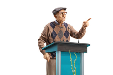 Mature male speaker talking on a pedestal and gesturing with finger
