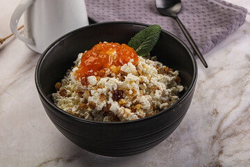 Curd with granola and orange jam