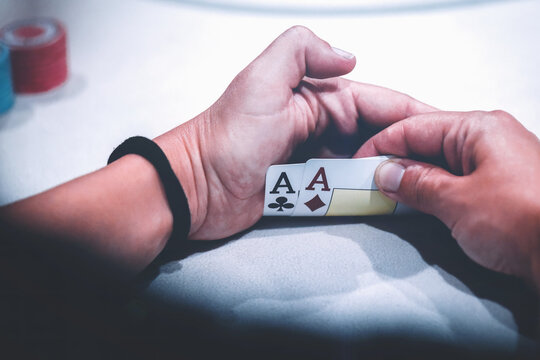 Player Holding Two Aces During a Tense Poker Game at a Casino Table