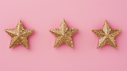 Fototapeta na wymiar Three glittering golden stars on a pink background