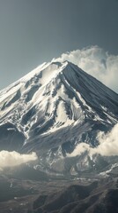 Snowy mountain peak with clouds