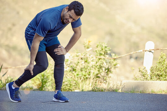 Man, running and calf pain or outdoor cramp on mountain path in nature with muscle inflammation, injury or hurt. Male person, bruise and marathon training with leg or suffering, accident or strain