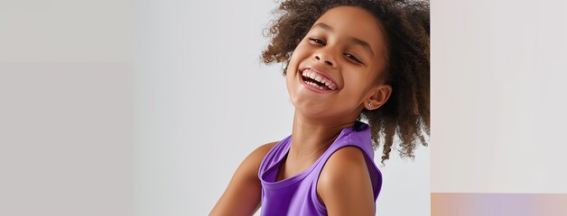 purple color base layer thin vest and solid color shorts set for kids from the spring-summer 2024, 2025 collection, as a girl model poses with joy, turning right and radiating laughter .