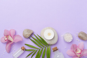 Composition with orchids, spa products on color background, top view