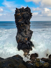 Fototapeta premium The rock pillar in the sea with rough waves at the Santa Barbara beach on San Miguel, Azores. 