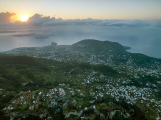 Vista aerea all’alba dal monte Epomeo a Ischia. Volo tra le nuvole con vista mare