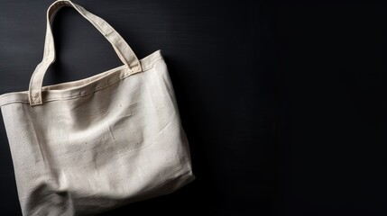 Mockup of a white fabric tote shopping bag on a black backgroud background