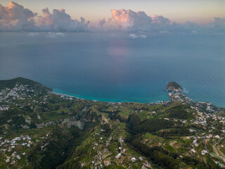 Aerial view at dawn from Mount Epomeo in Ischia. Flight in the clouds with a sea view