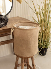 Jute basket for storing laundry, clothes, toys. Round basket in bathroom. Natural