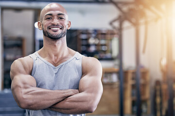 Man, portrait and arms crossed in gym with muscles for training client, strong body and health...
