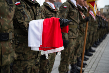 The Polish flag held by a soldier during the ceremony