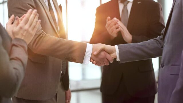 Businessman making handshake with his partner in office business etiquette,
