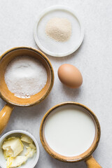 Overhead view of Mise en place of ingredients for making coco bread, ingredients for making jamaican bread on a table, process of making coco bread
