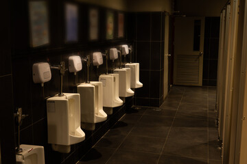 A row of urinals in a public restroom