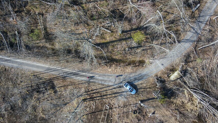 A car at the crossroads in the bush.
