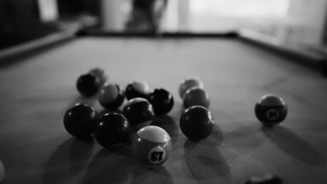 Breaking balls in American pool. Black and white.