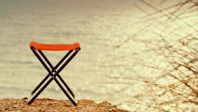 Empty folding camp chair on beach nature. Holidays relaxation on trip. Vacation in the camping. Freedom and travel concept.