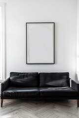 This minimalist living room exudes sophistication with its sleek black sofa against a backdrop of crisp white walls, featuring a pristine empty frame waiting for adornment.