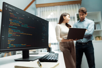 Coding software screens newest creative website on working desk against on developers program...