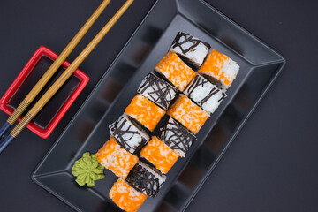 Sushi Composition with Soy Sauce and Wasabi on Dark Background