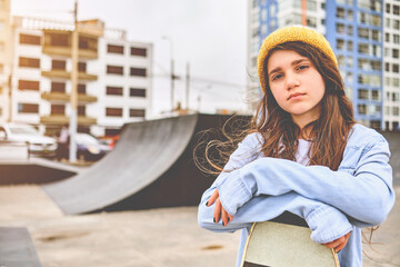Girl having fun riding skateboards at skate park, Portrait of smiling young female skateboarder...