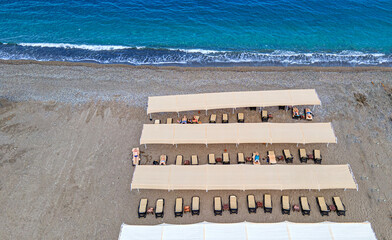 Aerial  view of the beach with sunbeds and umbrella at Kemer, Antalya by drone