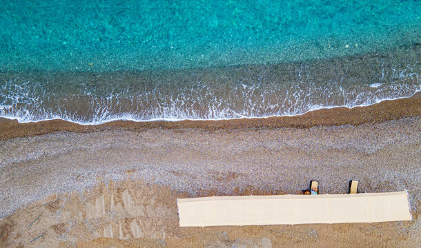 Aerial  view of the beach with sunbeds and umbrella at Kemer, Antalya by drone