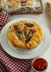 bread with sausage meat and spicy sauce, served on a white plate