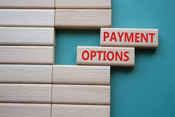 Payment Options symbol. Concept words Payment Options on wooden blocks. Beautiful grey green...