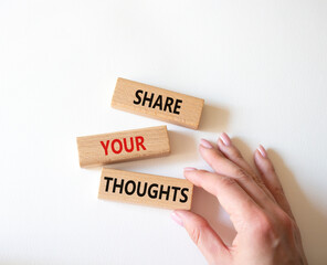 Share your Thoughts symbol. Concept words Share your Thoughts on wooden blocks. Businessman hand. Beautiful white background. Business and Share your Thoughts concept. Copy space.