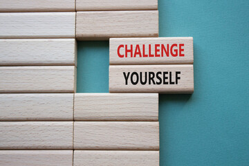 Challenge yourself symbol. Wooden blocks with words Challenge yourself. Beautiful grey green...