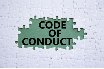 Code of conduct symbol. White Puzzle with words Code of conduct. Beautiful grey green background....