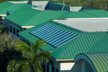 Top view of residential condo in USA with rooftop covered with solar photovoltaic panels for...