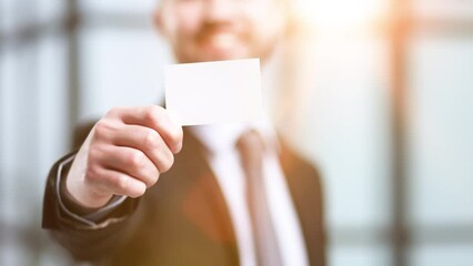 Portrait of serious confident smart modern investor banker executive boss manager freelancer showing card